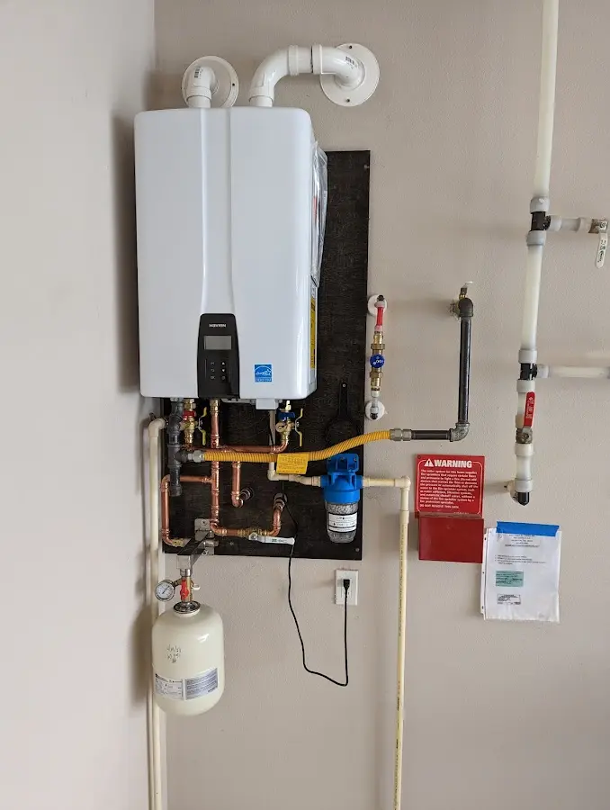 Professional plumber installing copper piping in a Saginaw home